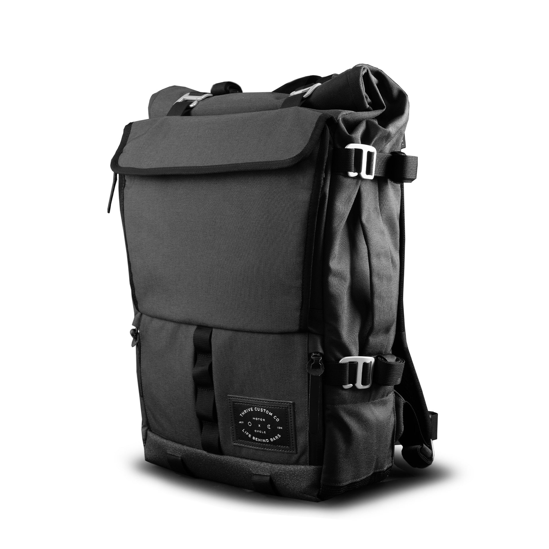 The Peloton Asphalt S backpack, front three-quarter view, black roll-top with LBB x Thrive patch.