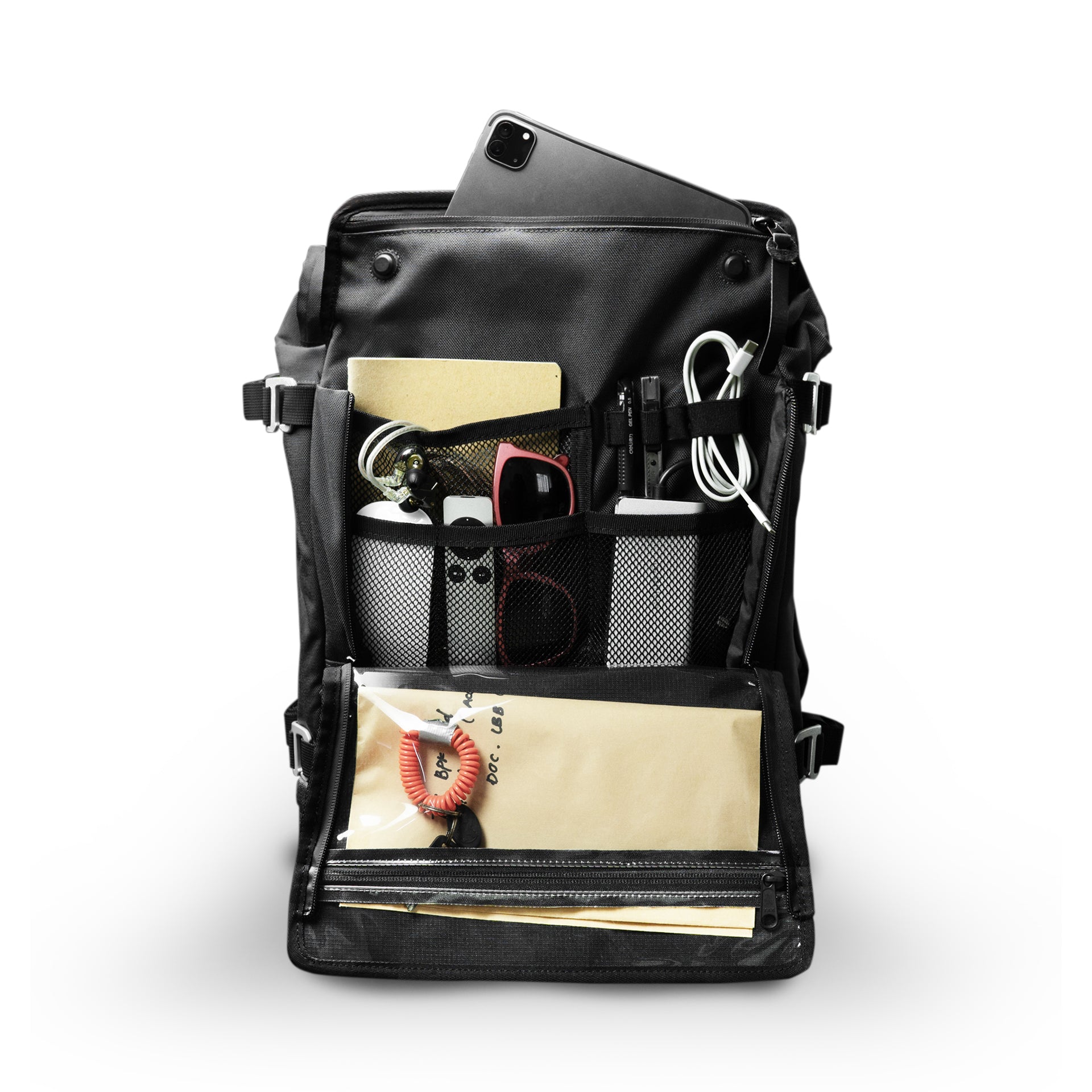 Open EDC flat-lay: tablet, notebook, cables, sunglasses and pens organised across the Asphalt S mesh admin pockets.