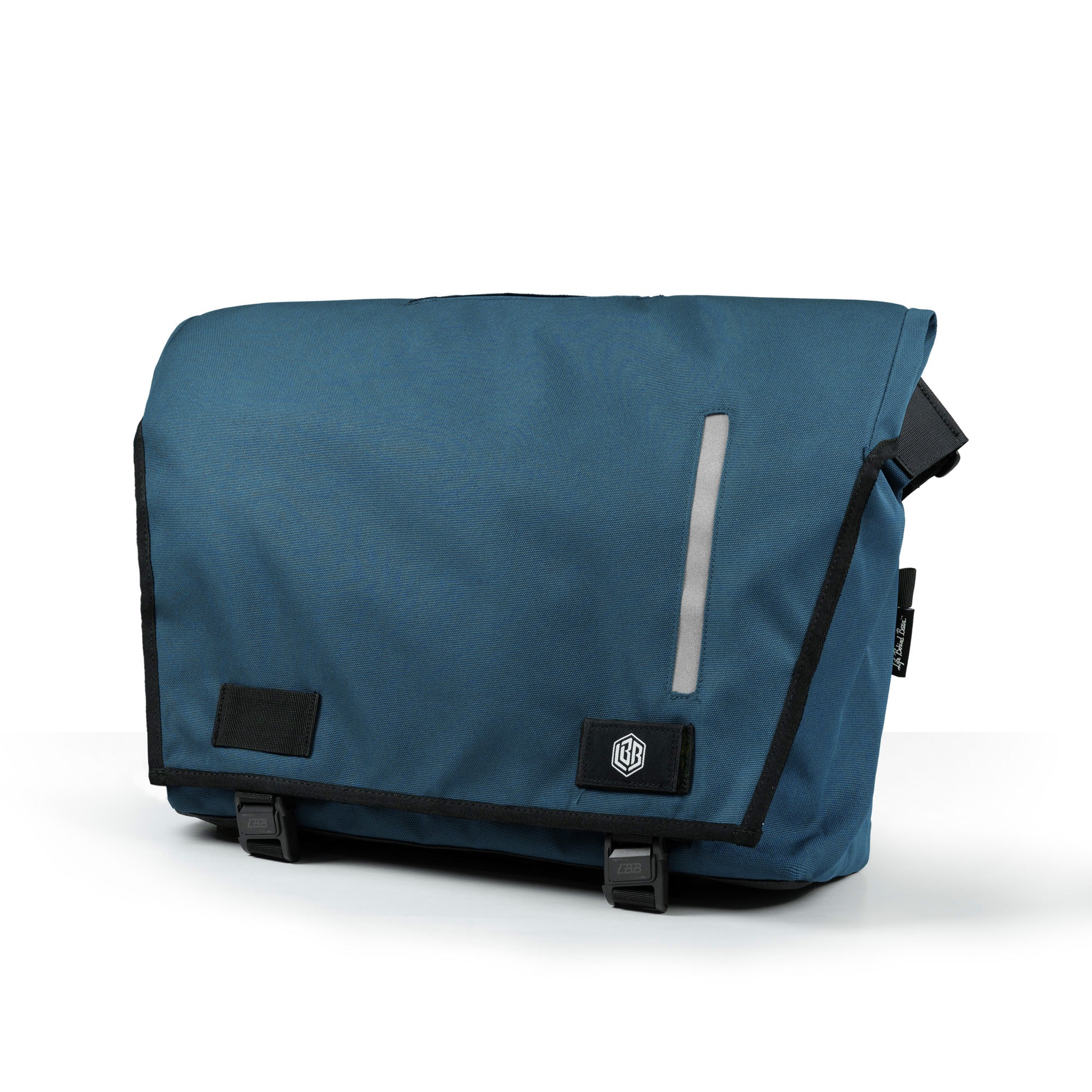 The Echelon M messenger bag in teal blue with reflective flap detail and hex LBB patch, three-quarter view on white.
