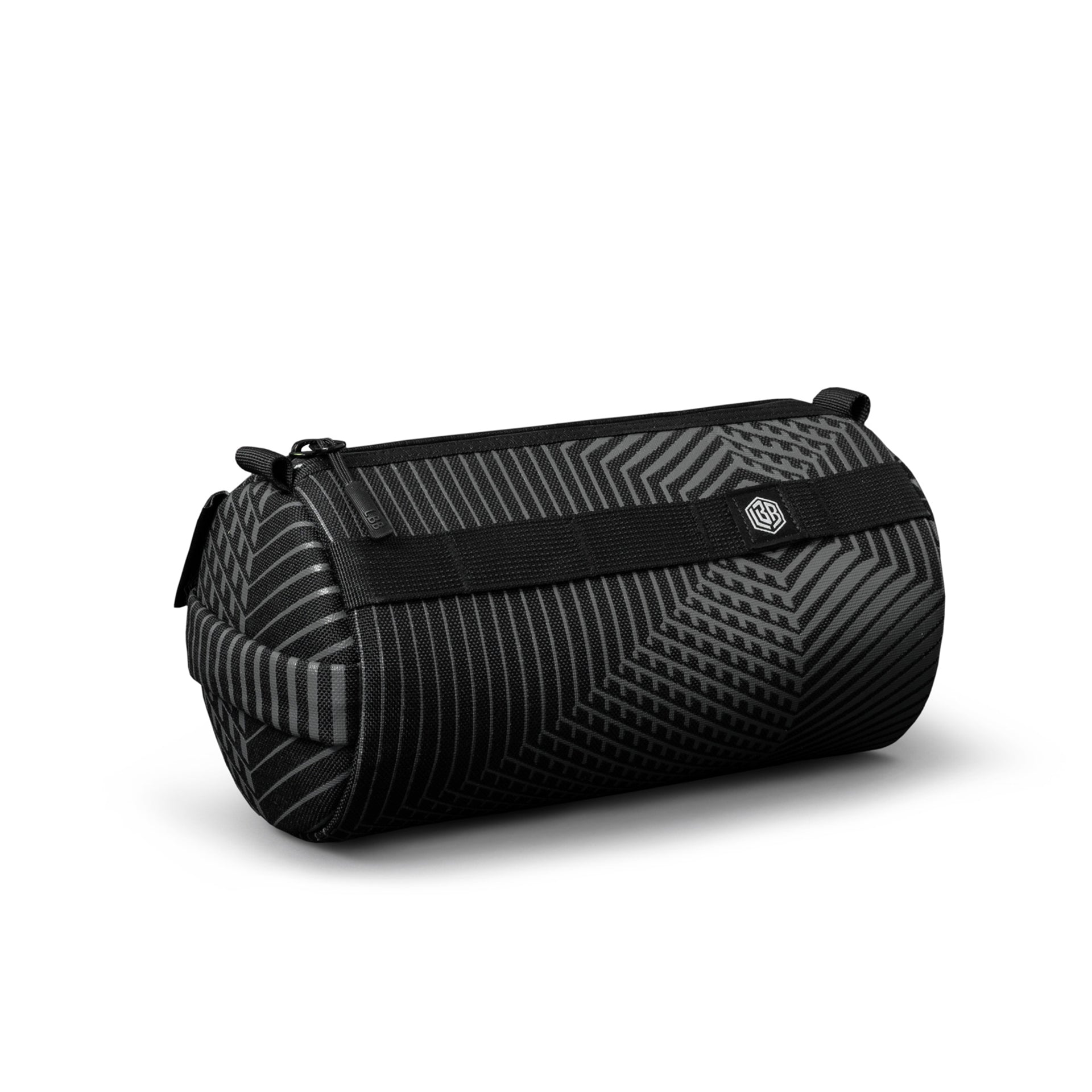The Rouleur Sonar handlebar bag, a cylindrical bar bag in black with a grey geometric sonar print, three-quarter view on white.