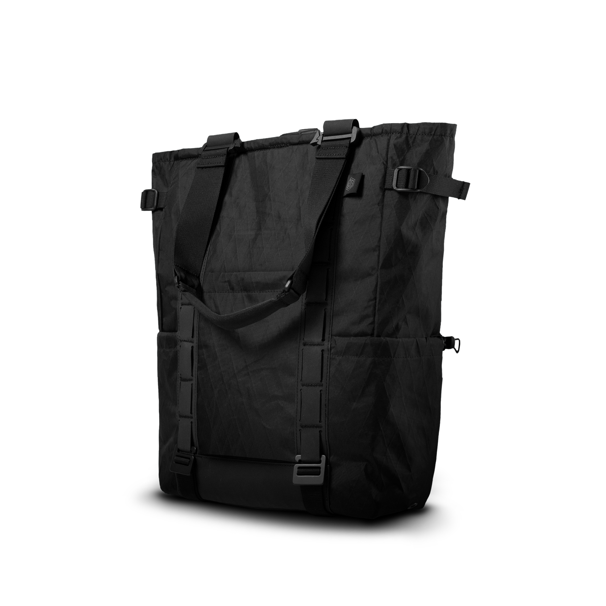 The Transition RX convertible totepack in blacked-out X-Pac with tote handles, backpack straps and daisy-chain webbing, front view.